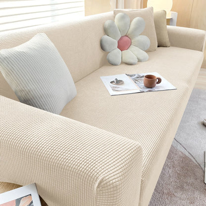 Detalhe do toque e textura da capa de sofá ajustável em jacquard resistente - Vittara Decor
