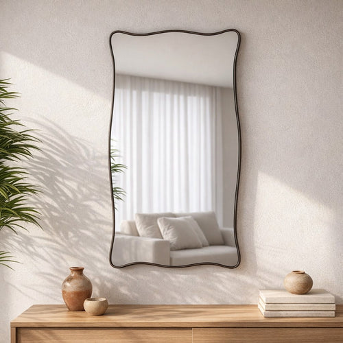 Espelho orgânico ondulado na parede da sala, acima de aparador de madeira clara - Vittara Decor