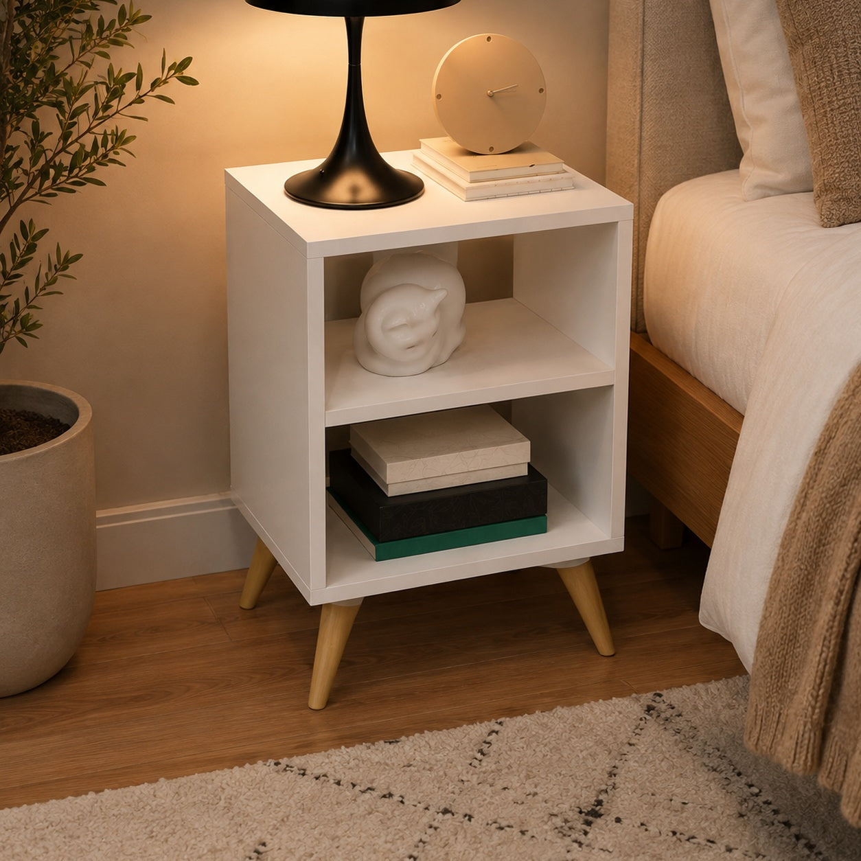 Mesa de cabeceira retrô branca com abajur sobre o tampo e livros no nicho - Vittara Decor