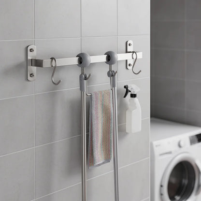 Suporte inox para vassouras montado em lavanderia com ferramentas de limpeza organizadas verticalmente - Vittara Decor