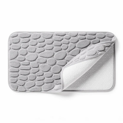 Tapete antiderrapante absorvente cor Cinza em algodão com padrão seixos em relevo em fundo branco - Vittara Decor